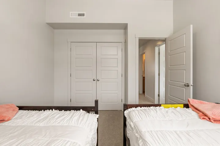 Room featuring light gray walls, white baseboards, and neutral-toned carpeting