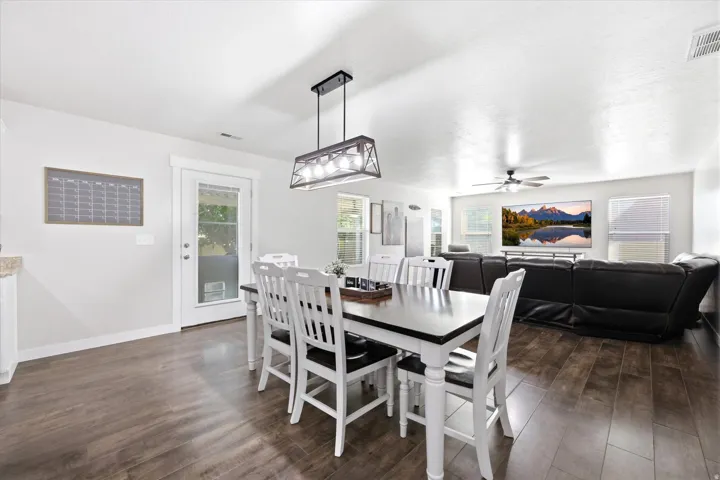 Open-concept living space featuring wood-finish flooring, recessed lighting, and white trim