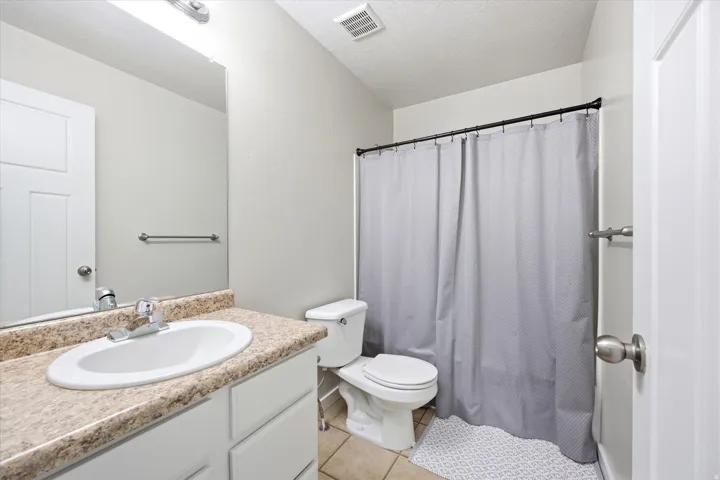 Bathroom featuring a vanity with an integrated sink, a neutral-toned countertop, and recessed lighting