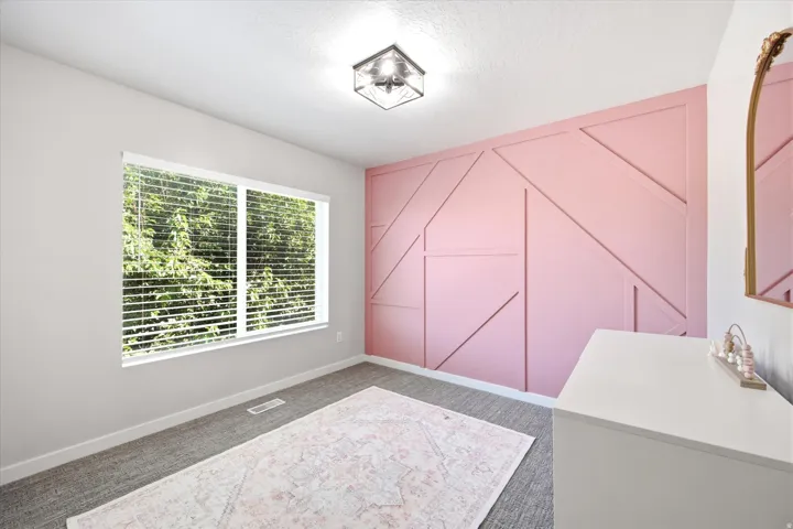 Geometric accent wall featuring a pink finish