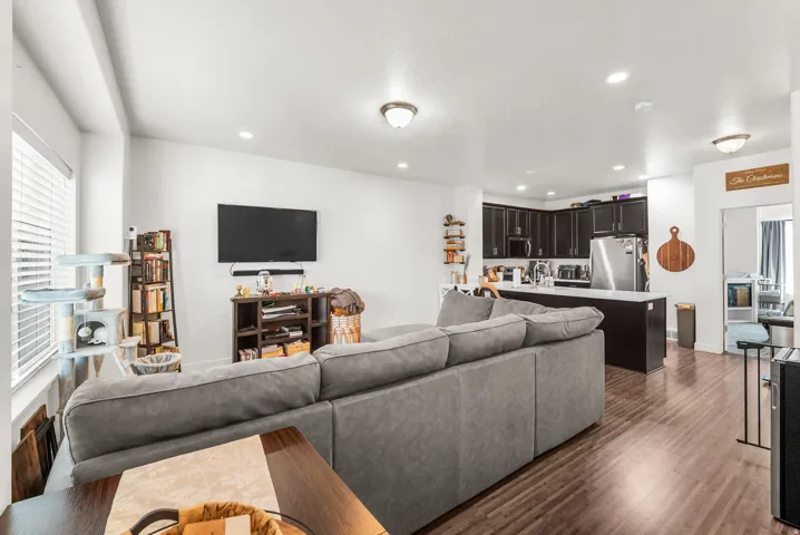 Open-concept living area featuring wood-finish flooring and recessed ceiling lights