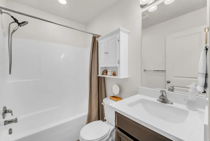 Bathroom featuring a white bathtub and shower combination with a curved shower rod