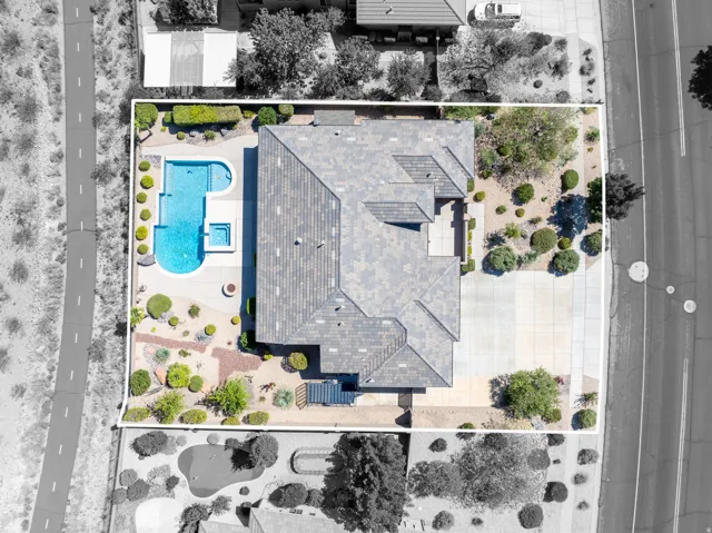 Aerial representation of a residential property featuring a patterned tile roof and a concrete driveway