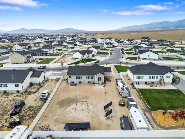 Expansive property with a large backyard, multiple RV parking areas, and a visible playground structure