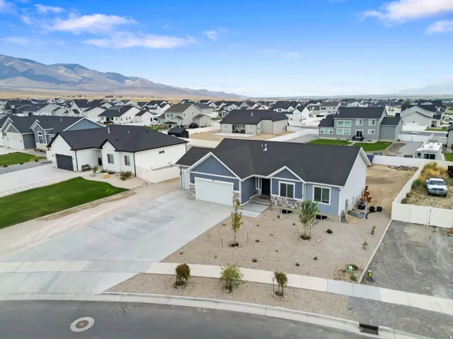 Contemporary exterior with a stone accent facade, attached garage, and gravel landscaping