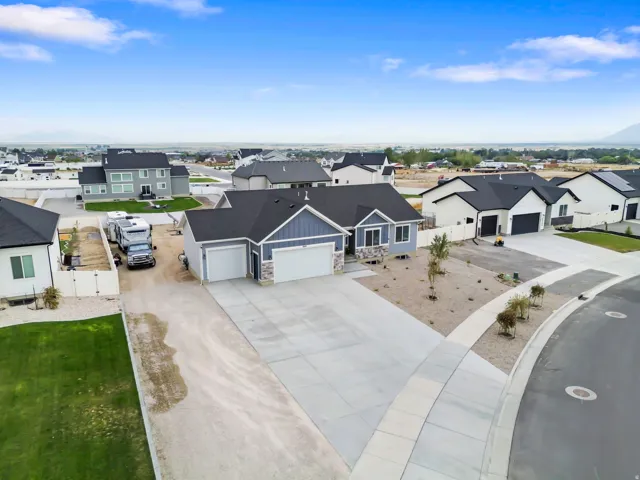 New construction residence featuring a two-car garage, stone and siding exterior, and a concrete driveway
