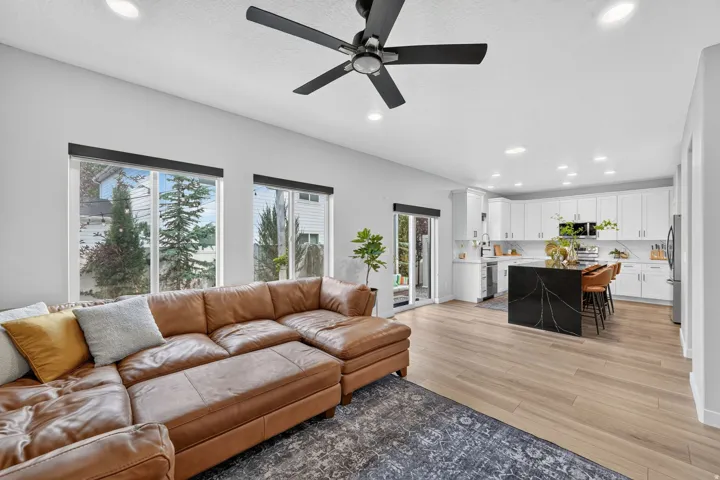 Open concept living space featuring wood-finish flooring, recessed lighting, and a modern ceiling fan