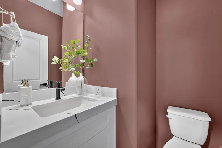 Vanity with integrated rectangular sink and matte black faucet, featuring a patterned countertop