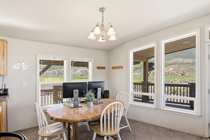 Dining area featuring a multi-pane chandelier and expansive windows
