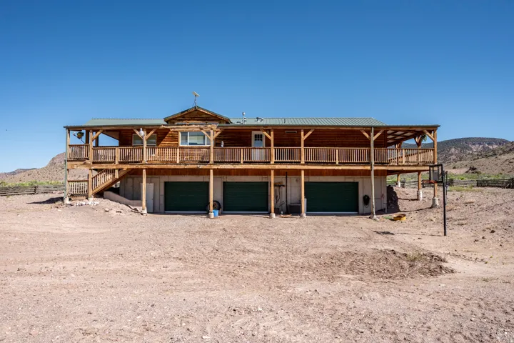 Log-sided home featuring a wrap-around porch and a covered deck