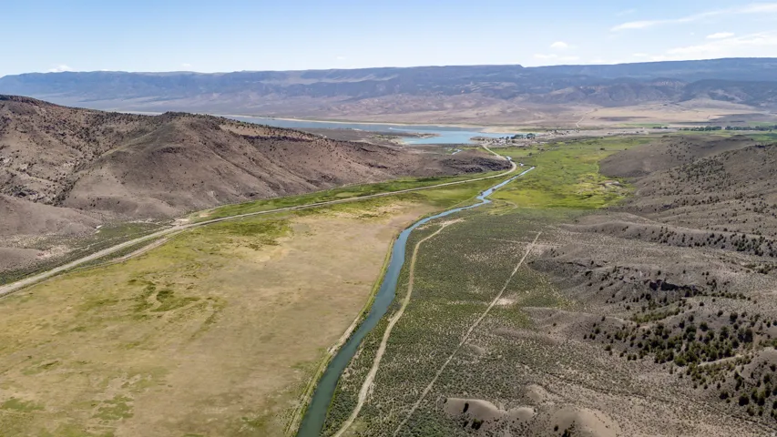 Expansive land parcel featuring natural waterways and a distant body of water