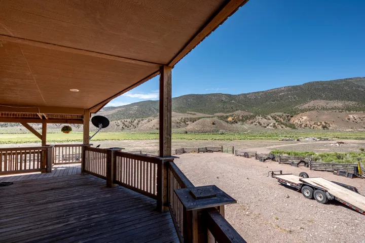 Covered porch featuring a wood-finish deck and railing system