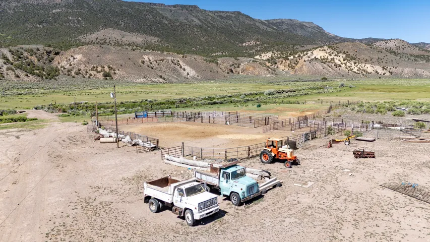 Expansive outdoor area featuring a round pen, multiple fenced enclosures, and a large open dirt field