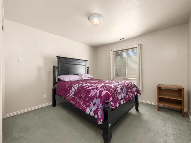 Neutral-toned walls complement the gray carpeting