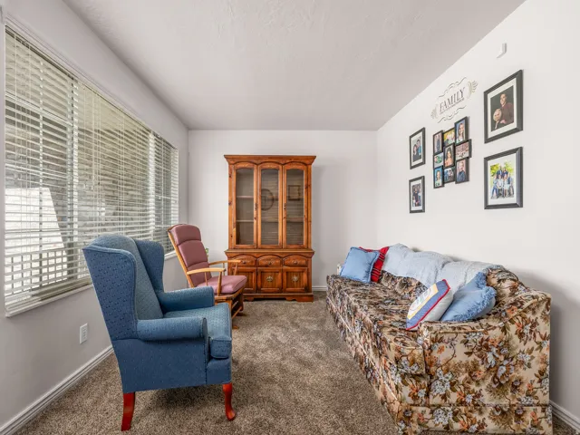 Spacious room featuring neutral carpeting and white wall paint