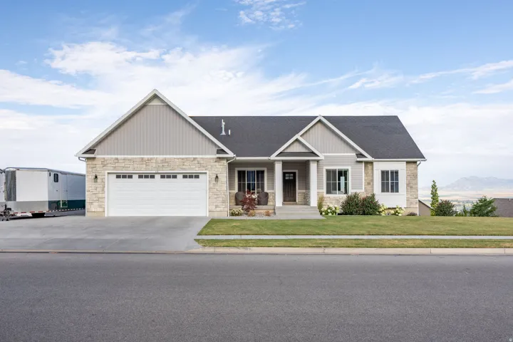 Contemporary ranch-style residence featuring stone and siding exterior accents