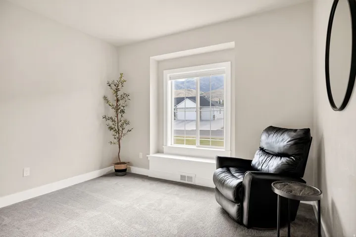Light-toned walls with neutral carpeting create a bright interior