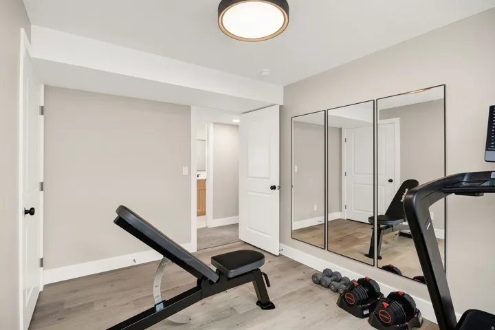 Versatile room featuring wood-finish flooring, light gray wall paint, and white trim