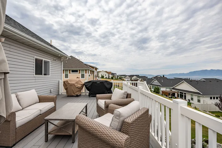 Expansive outdoor deck featuring composite decking and a white railing system