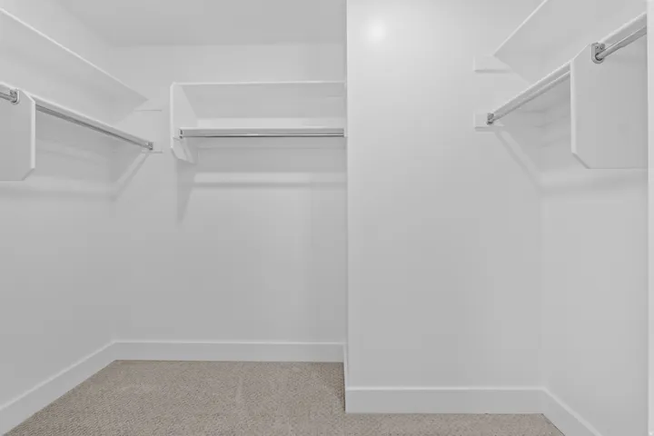Primary bedroom walk-in closet