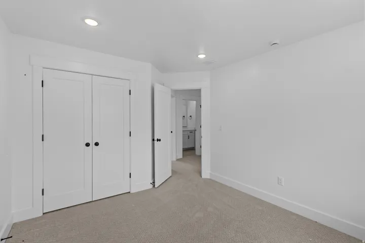 Room featuring light-colored carpeting, white walls, and recessed lighting