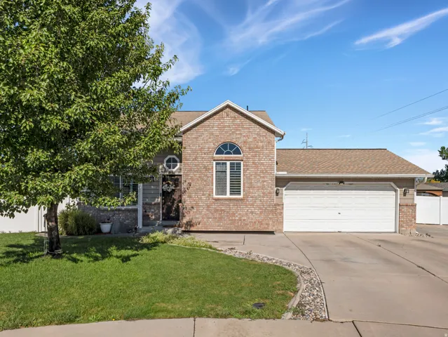 Brick and siding exterior with an attached garage