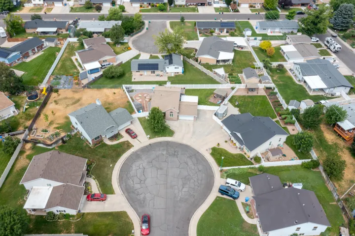 Residential cul-de-sac with multiple single-family homes, each featuring a private yard