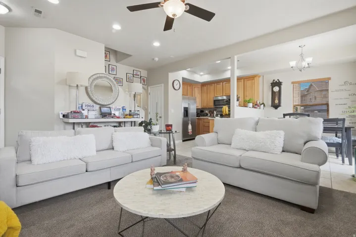 Open-concept living area featuring recessed lighting, a ceiling fan, and carpeted flooring