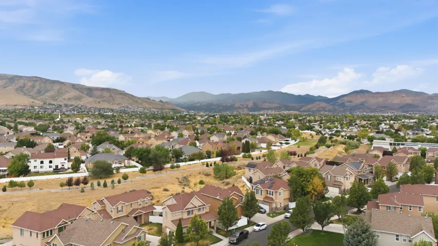 Expansive residential neighborhood featuring a variety of housing styles, mature landscaping, and mountain scenery