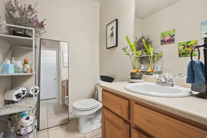 Bathroom featuring a wood-finish vanity with an integrated sink and chrome faucet