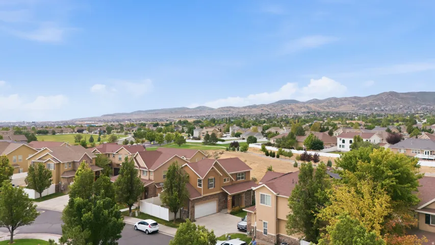 Expansive residential area featuring numerous properties with multi-gabled roofs and varied exterior finishes