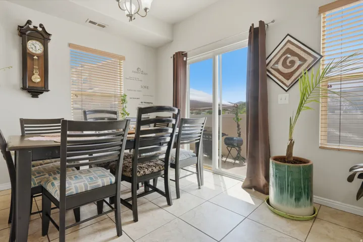 Dining area featuring tiled flooring, a multi-light chandelier, and access to an outdoor patio through sliding glass doors