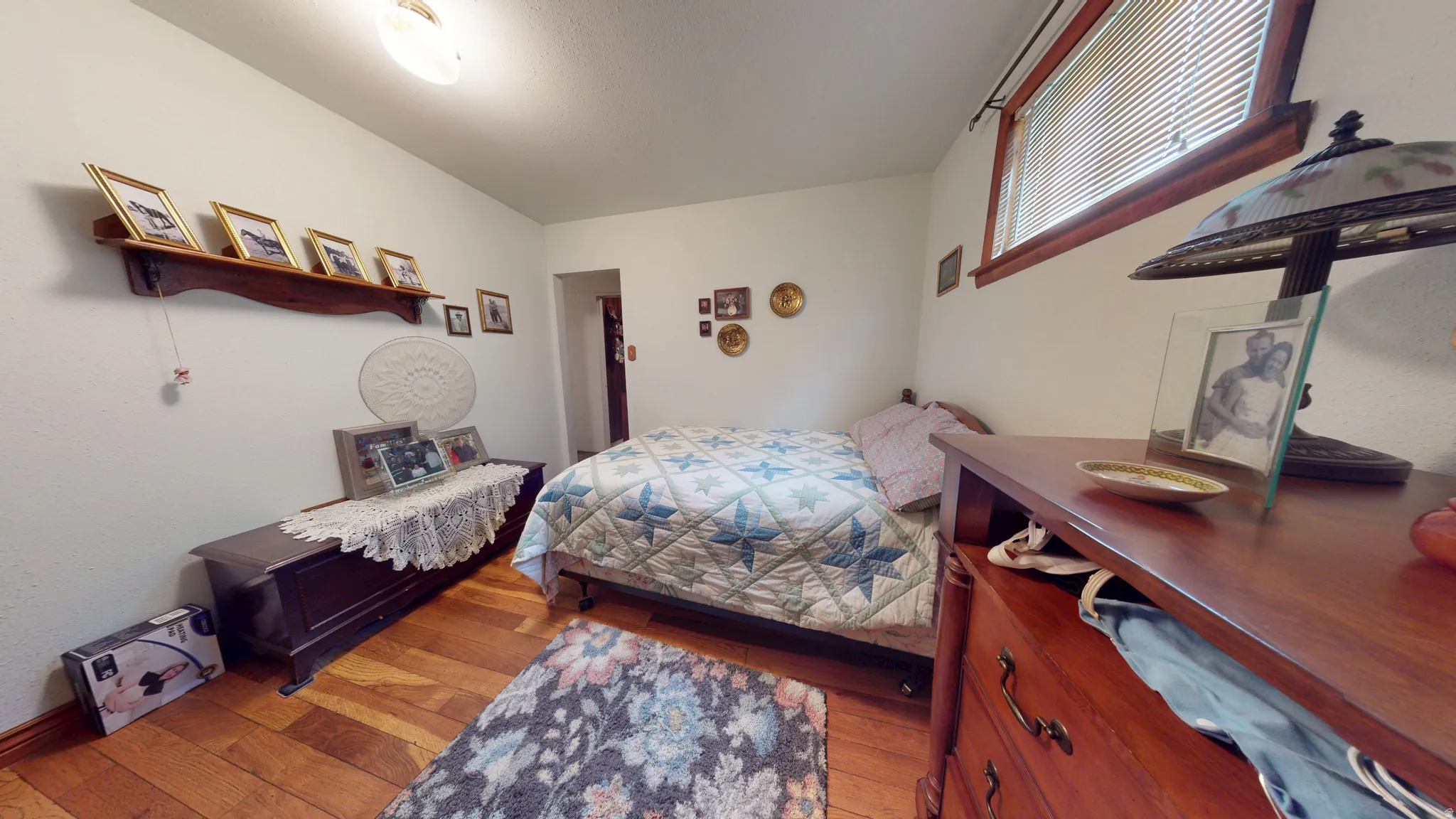 Interior room with wood-finish flooring and white painted walls