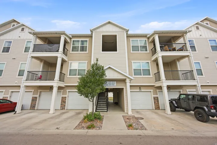 Multi-story building featuring tan siding and stone veneer accents