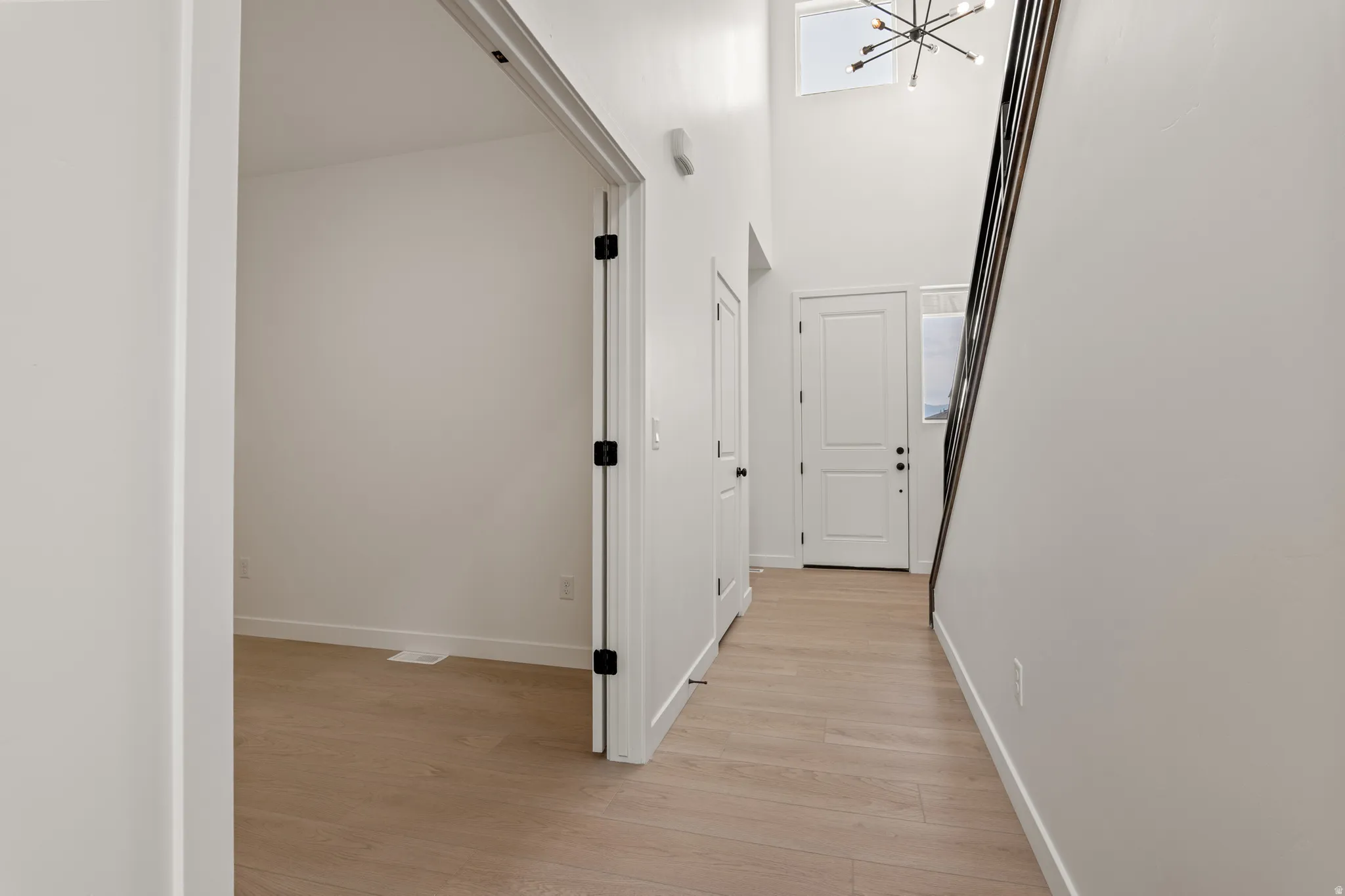 Entryway featuring wood-finish flooring and a two-story ceiling