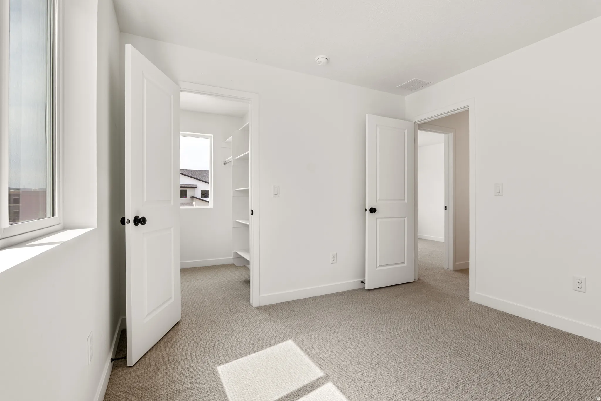 Neutral tone wall finishes throughout this carpeted room