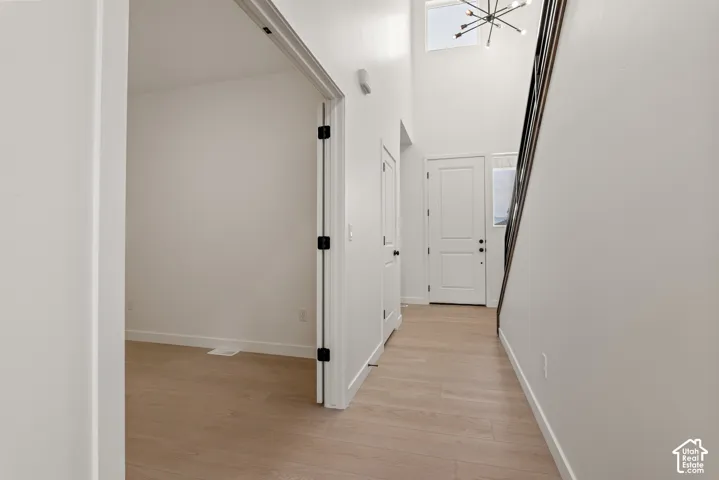 Entryway featuring wood-finish flooring and a two-story ceiling