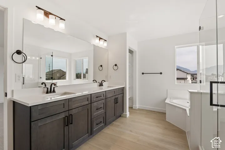 Dual vanity featuring dark wood-finish cabinetry, quartz countertops, and matte black fixtures