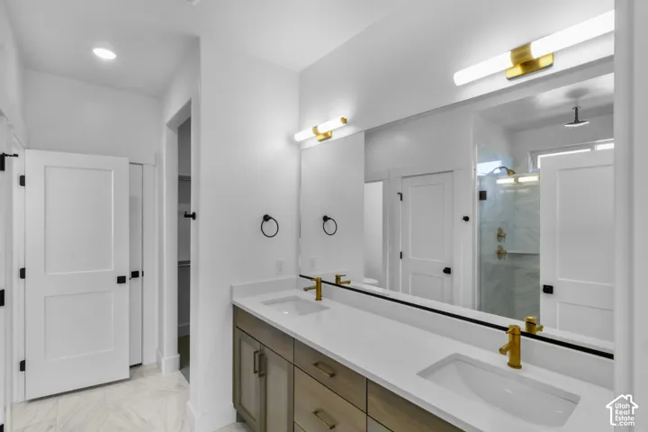 Dual vanity with integrated rectangular sinks and brass-finish fixtures