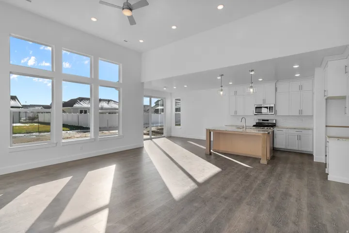 Open-concept living space featuring wood-finish flooring and a contemporary kitchen