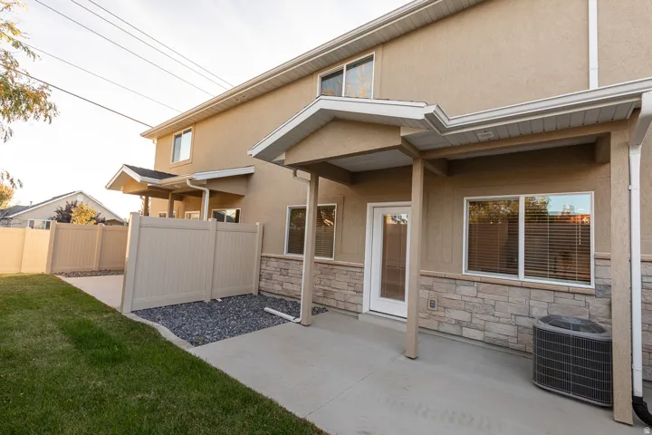 Exterior patio featuring a concrete surface, covered entry, and stone veneer accents