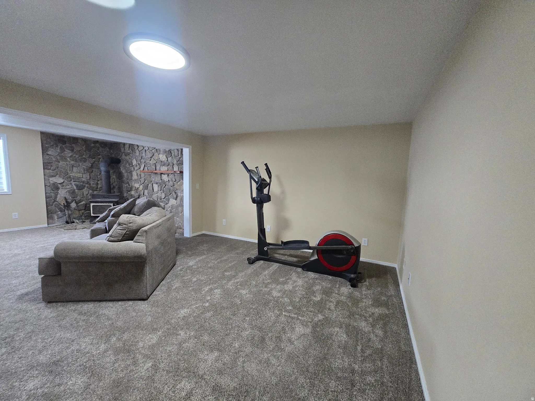Spacious room featuring neutral carpet flooring and light-toned walls