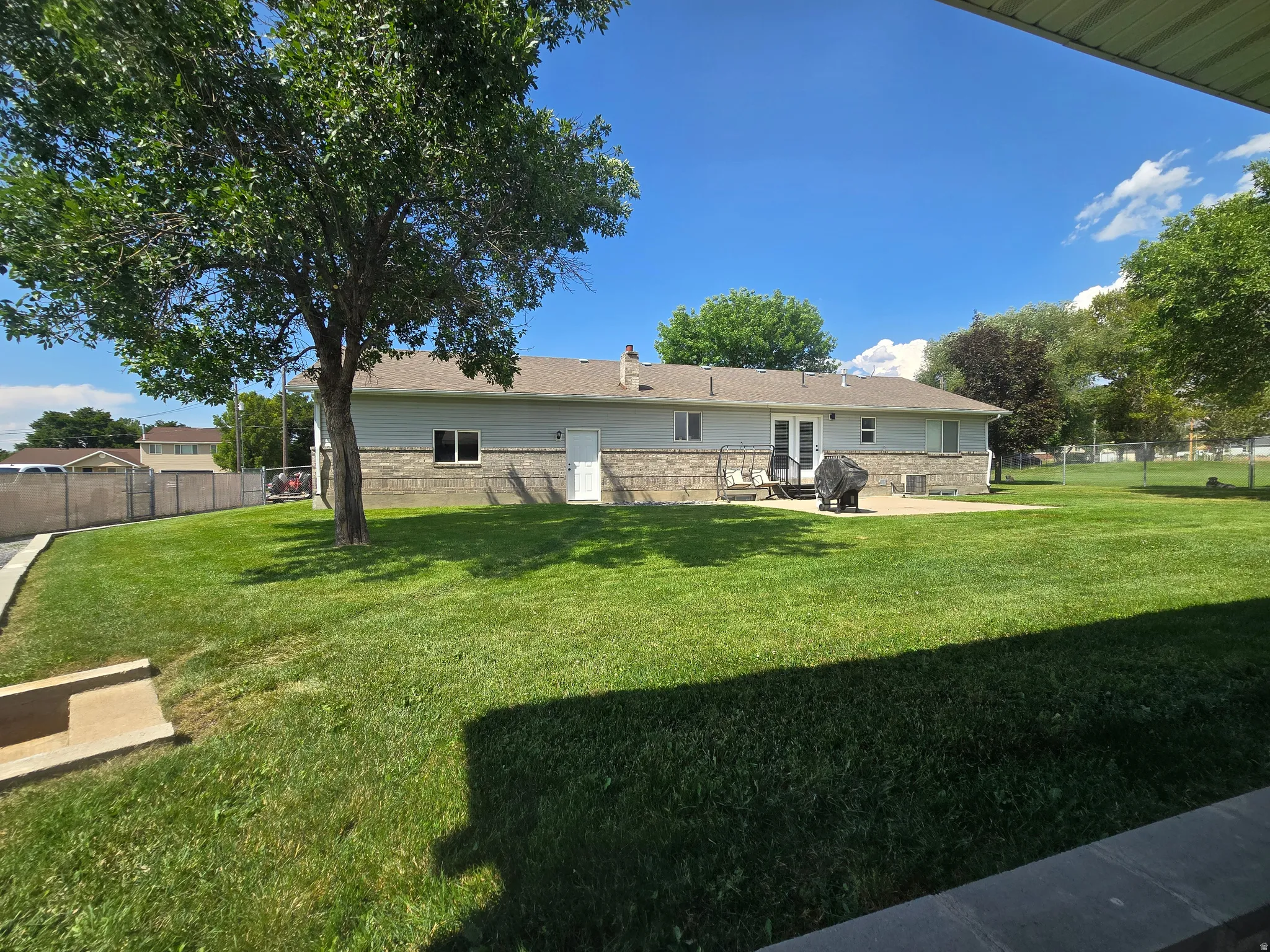 Expansive green lawn with mature trees