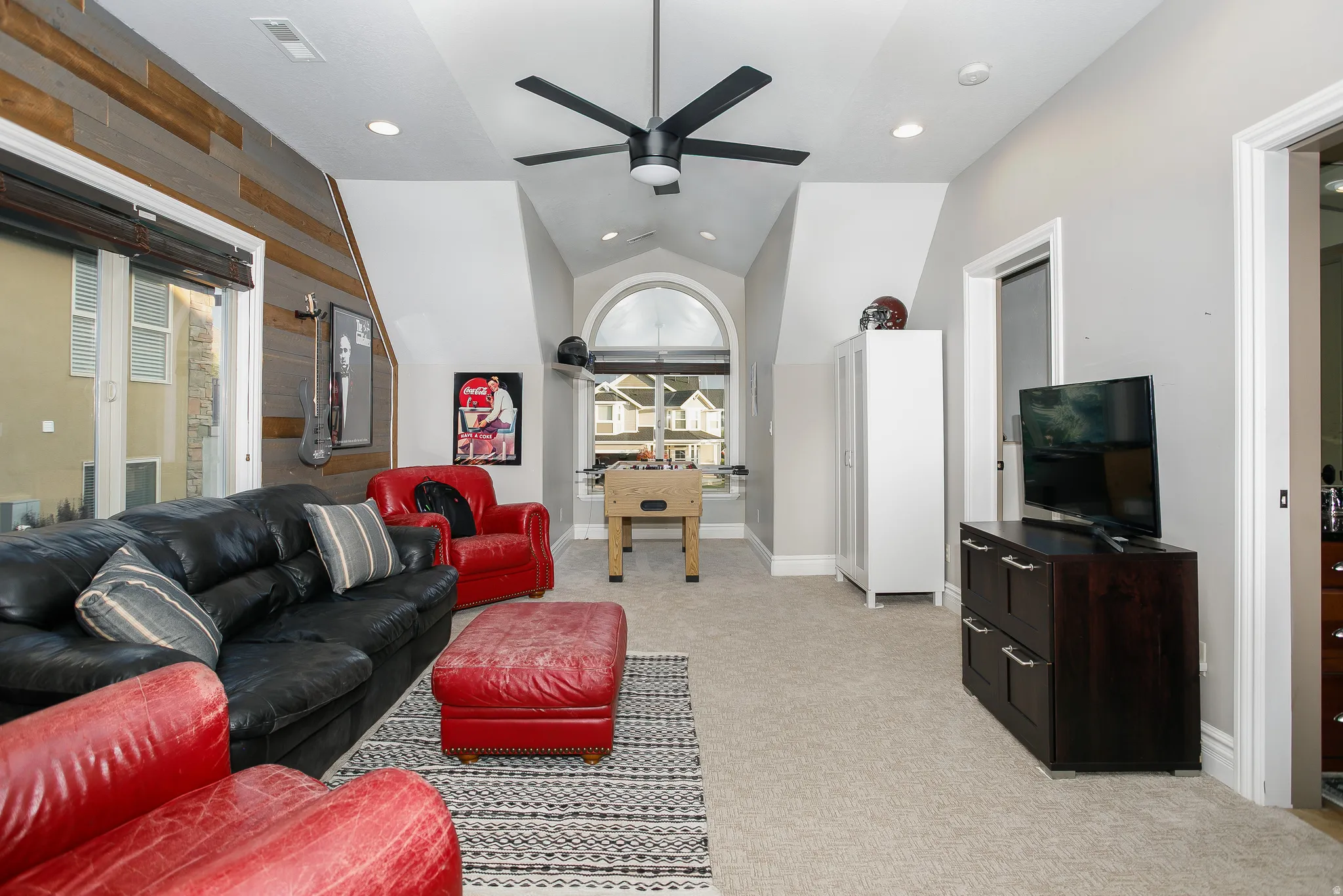 Vaulted ceiling room with recessed lighting and a ceiling fan