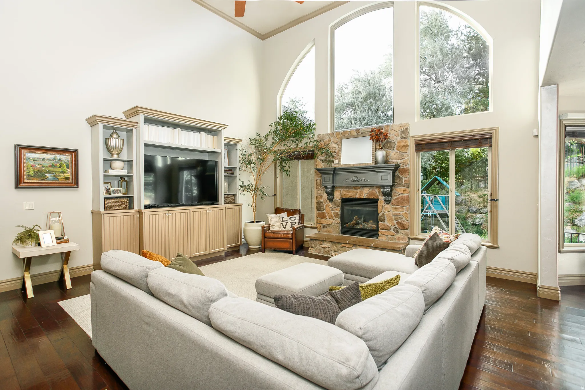 Living area with vaulted ceilings and wood-finish flooring