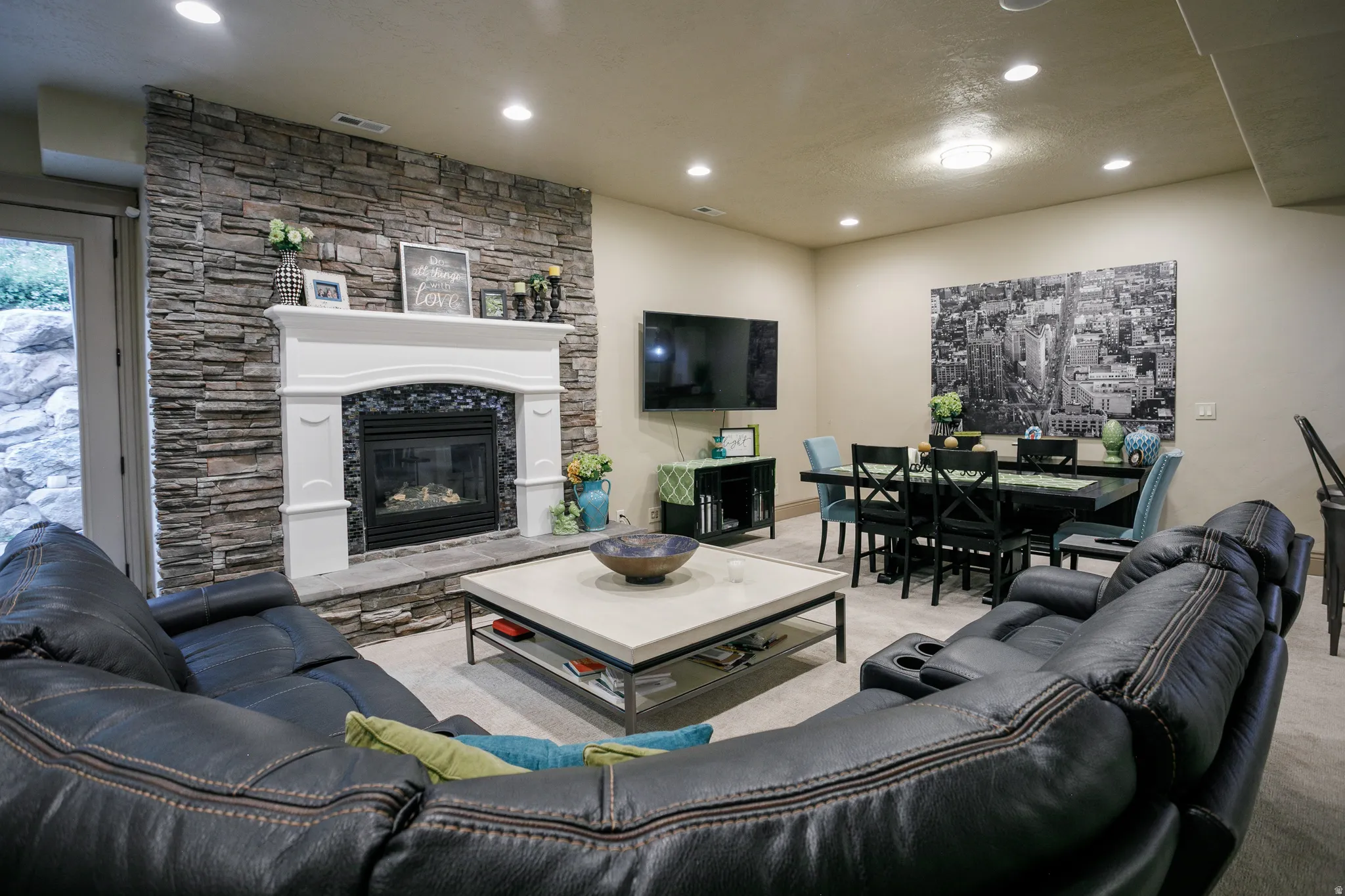 Stacked stone fireplace with a white mantel and hearth