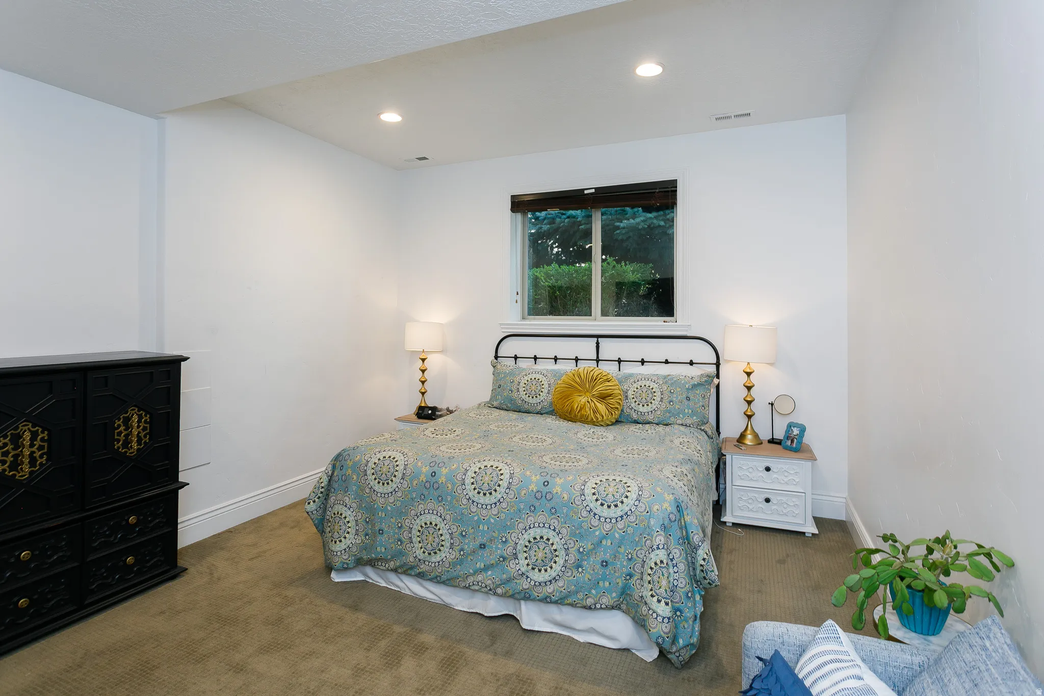 Bedroom featuring recessed lighting, a window with exterior foliage, and carpeted flooring