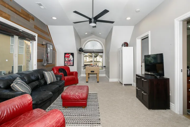 Vaulted ceiling room with recessed lighting and a ceiling fan