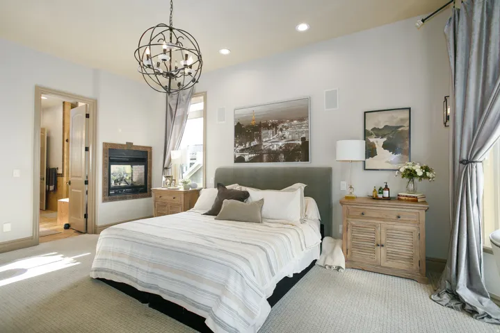 Carpeted room featuring a built-in fireplace, spherical iron chandelier, recessed lighting, and direct access to a bathroom