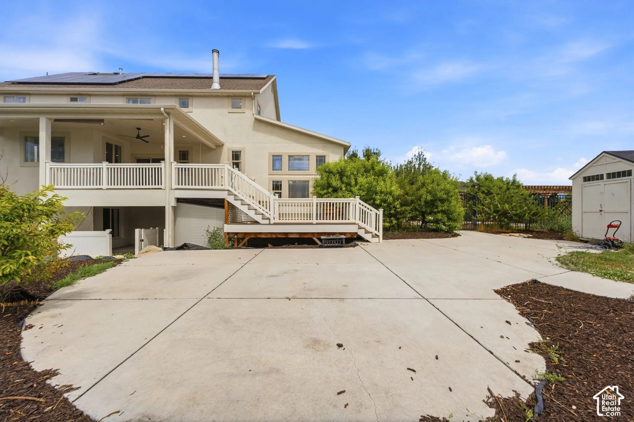 Expansive concrete patio with multiple access points to the property